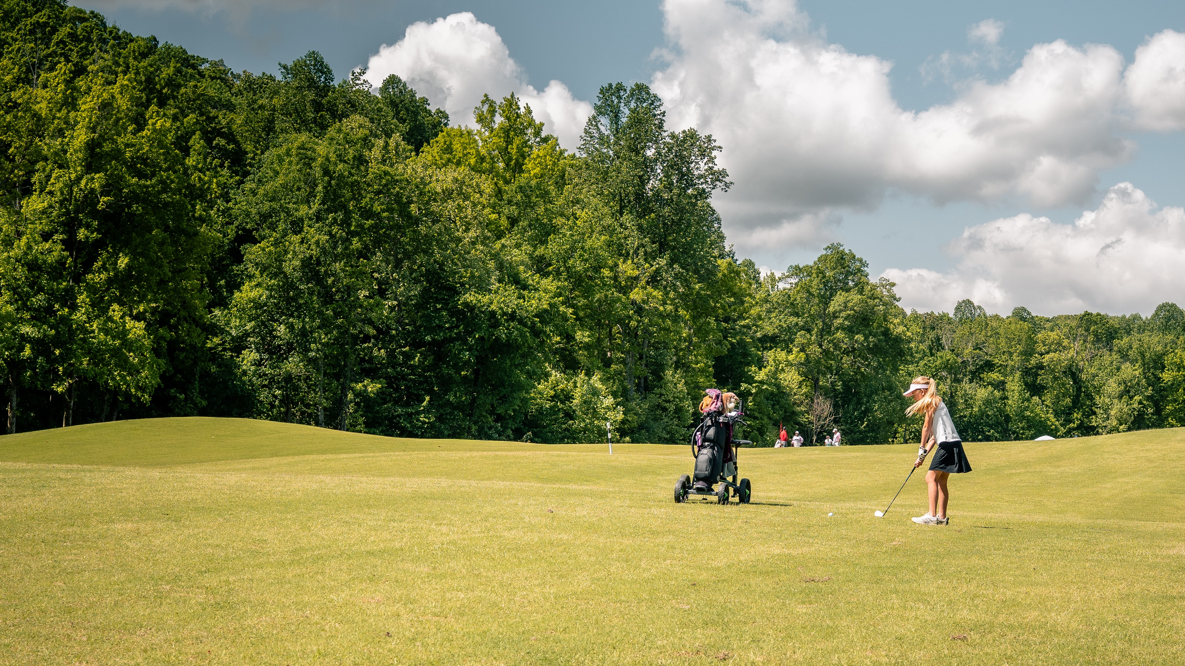 Junior golfer practicing on fairway